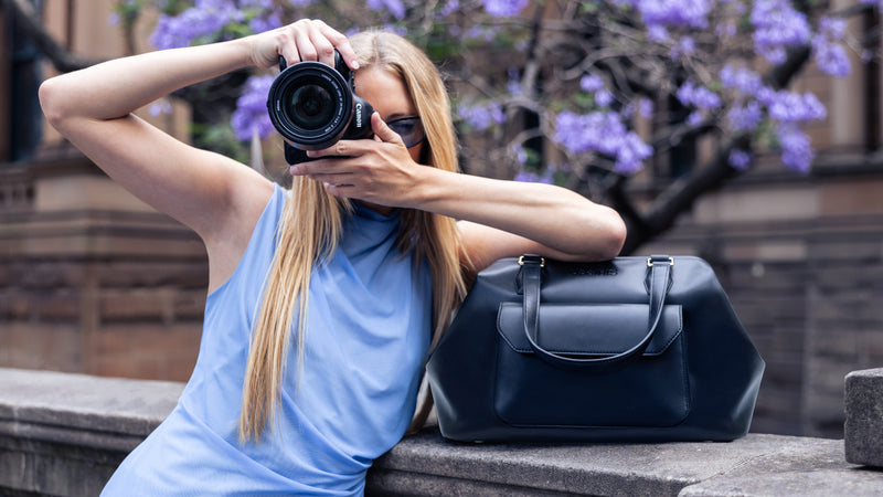 Luxury Noir Mirage camera bag in black, with adjustable dividers to protect DSLR and mirrorless cameras, offering a fashionable handbag style for creatives. Professional stylish camera bag that is as functional as chic